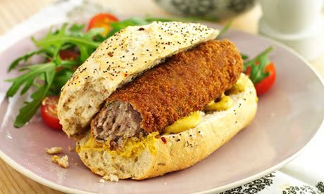 Croquette ("kroket") on a roll, with mustard.

A bite has been taken off the start of the croquette, showing the meat ragout inside of it.